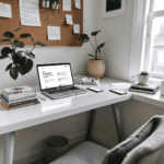 A home office with a laptop showing the Readwise and Pocket apps, surrounded by books and a smartphone. The workspace is bright and airy, with plants and a bulletin board, creating a productive atmosphere.
